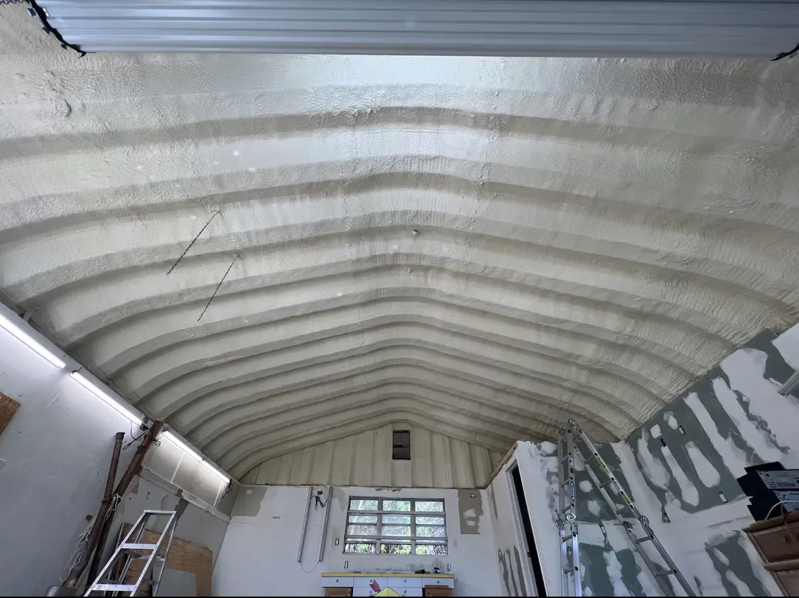 Spray polyurethane foam applied to the underside of a metal roof deck in Brecknock